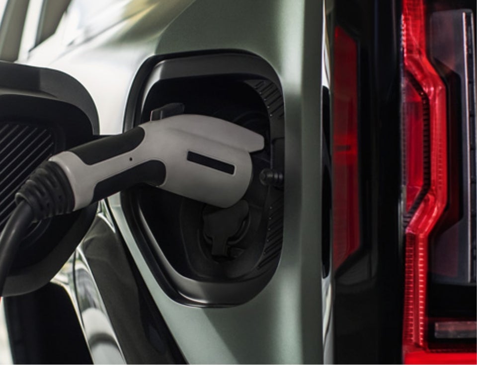 Close up of charging port with charger plugged in on a GMC Hummer EV SUV - Bokman of Wellsville GMC in WELLSVILLE NY